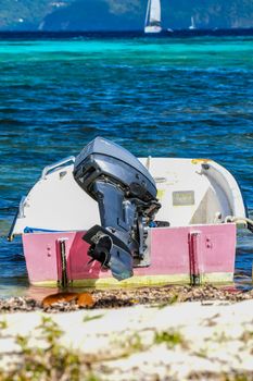 Dinghy with outboard moored in shallow water on British Virgin Islands beach