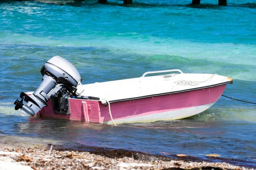 Pink dinghy on beach in the British Virgin Islands