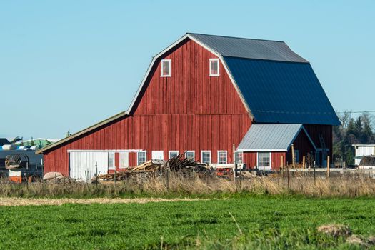 Situated on green field with clear, blue sky above.