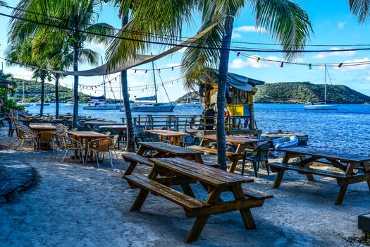 Evening breezes sway the palms on this idylic beach setting at a beachside bar on Virgin Gorda