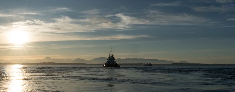 Late afternoon view across Puget Sound with Olympic Mountains, Washington State Ferry, and Tug.