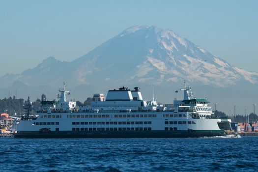 Washington State Ferry in front of Port of Seattle Cargo Terminal and Mount Rainier.