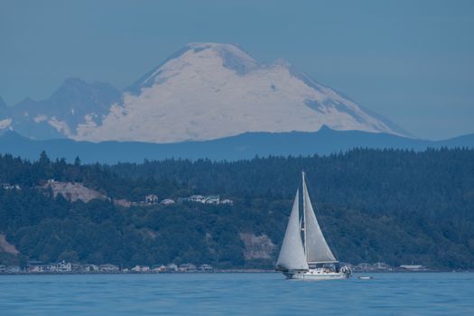 Stormy Monday sails lazily across Shilshole Bay with Mount Rainier in the background.