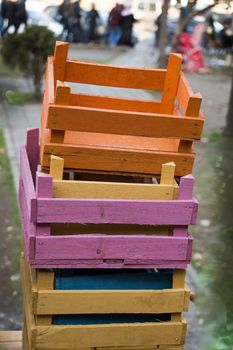 Colorful wooden empty crate boxes for sale in a market place