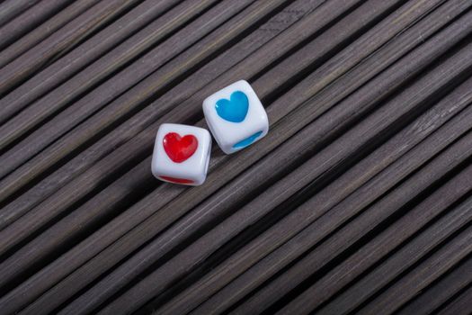 Colorful heart shaped love cubes  on a straw mat