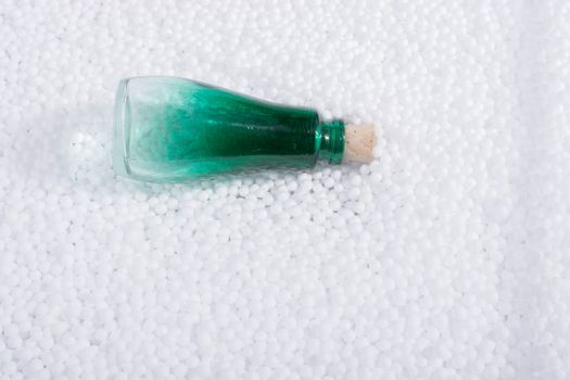 Empty bottle on little  white polystyrene foam balls