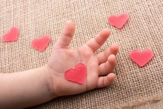 Heart shaped object  in the hand of a toddler