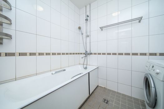 Small beige tile bathroom with bath tube and sink