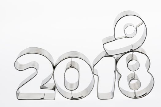 Text two thousand eighteen and nineteen in metal put figures on a white background as a visualization of the coming new year
