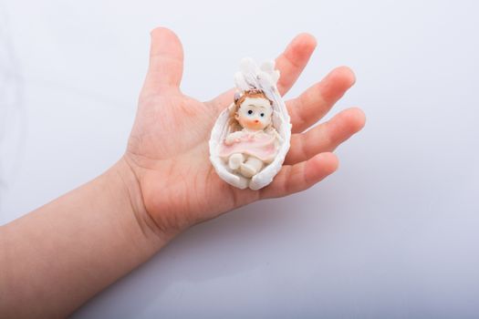Little baby figure in hand on a white background