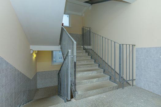 empty entrance in apartment building stairwell beige color