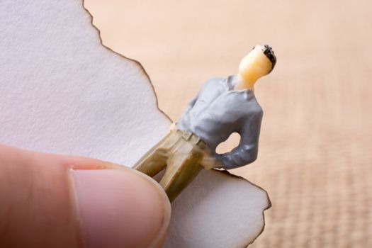Man figurine held in hand on canvas