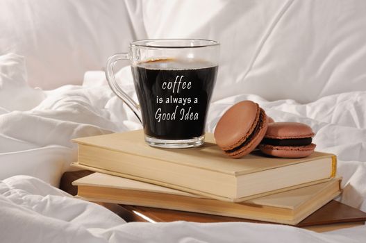 Morning cup of coffee with chocolate cakes Macaroons, on a pile of books in bed.
Coffee is always a Good idea.
