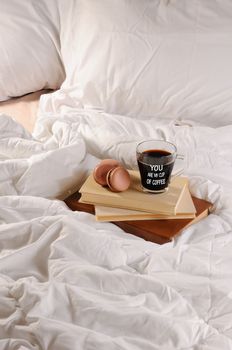 Morning cup of coffee with chocolate cakes Macaroons, on a pile of books in bed.
You are my cup of coffee.
