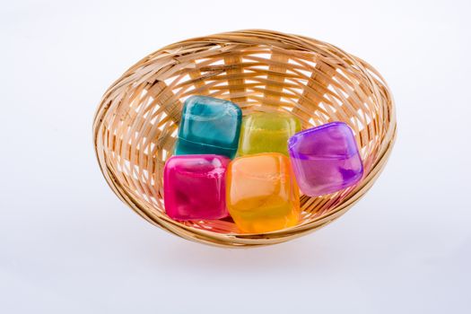 Fake colorful ice cubes  in basket on a white background