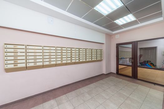 Empty hall mailboxes and doors at new apartment building