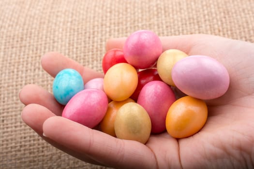 Candies in the concept  of Easter eggs in hand