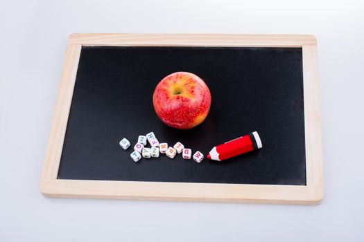 Back to school theme with a red apple and board