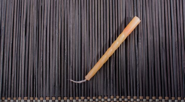 Colorful birthday candle  placed on a straw mat