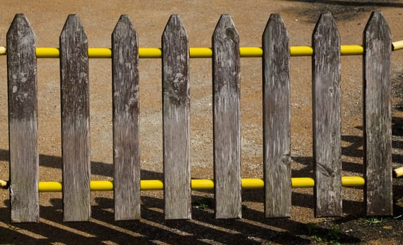 Part of a fence made of wood in view
