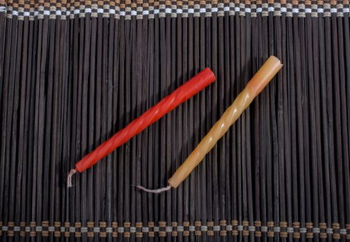 Colorful birthday candle  placed on a straw mat