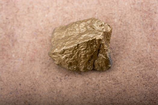 little gold color stone on brown background
