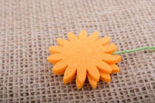 Fake flower placed on brown background