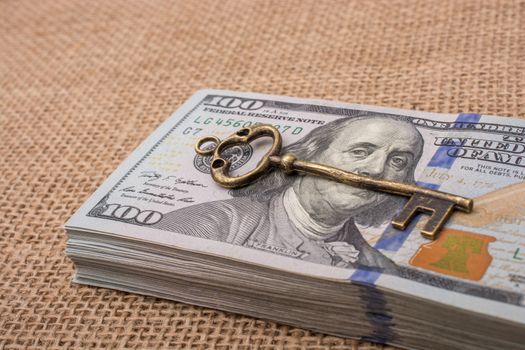 Retro styled key placed of a bundle of US dollar