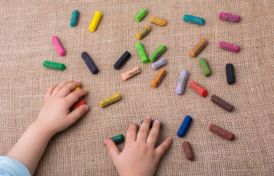 Used  color crayons and a toddlers hand holding one
