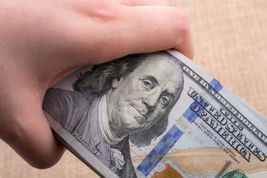 Close up of Benjamin Franklin face on 100 US dollar bill