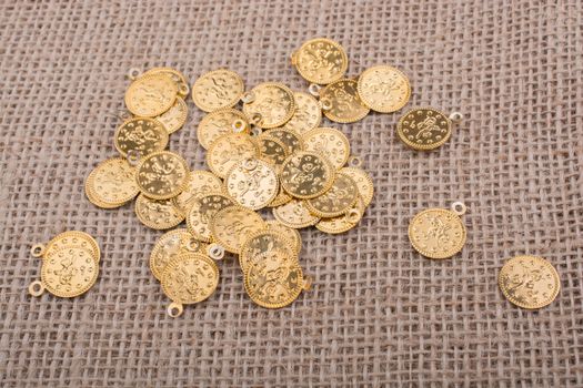 Plenty of fake gold coins are on canvas