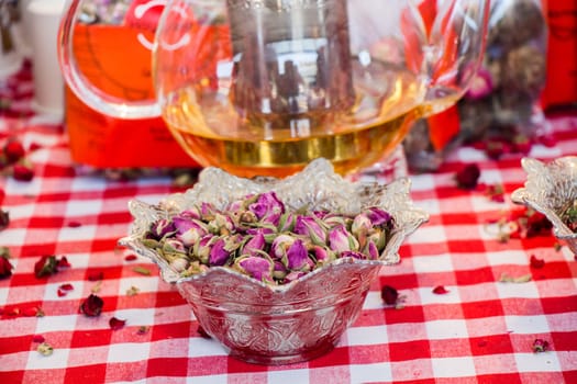 Herbal tea in glass teapot on table