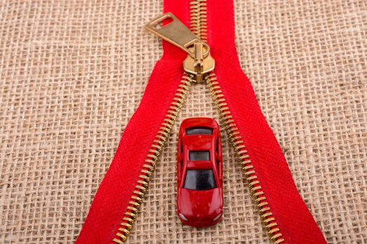 Toy car as a transportation devices in hand on a canvas background