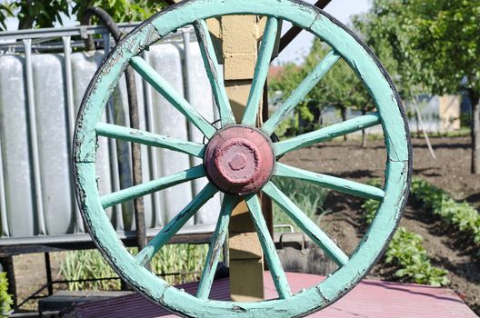 Green wooden cart wheel