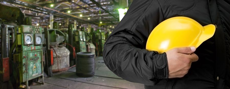 Worker with safety helmet at industrial factory