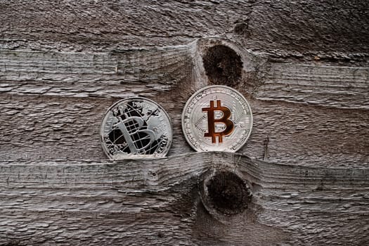 Digital currency physical silver bitcoin coins on the wooden background.