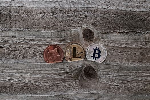 Digital currency physical gold silver and brass coins. Dogecoin, Litecoin and Bitcoin.