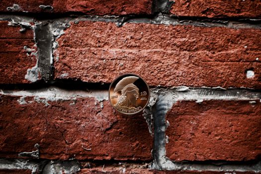 Digital currency physical gold titan bitcoin coin on the brick wall.