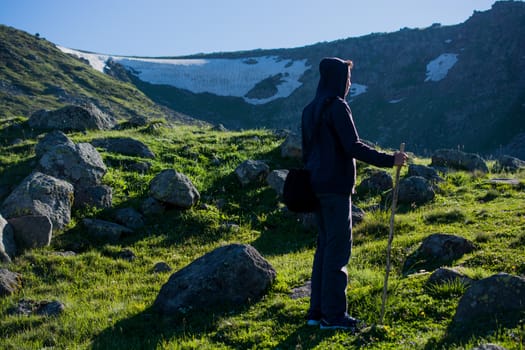 Young man  taking an excursion on a mountain