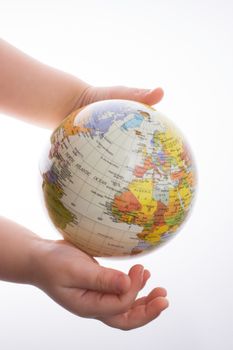 Child holding a globe in on a white background