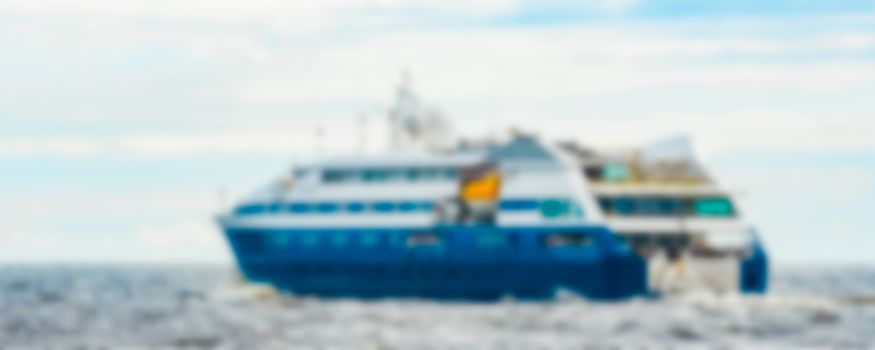 Blue passenger ship - soft lens bokeh image. Defocused background