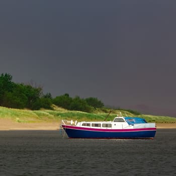 Small blue passenger ship moored at Baltic sea bay