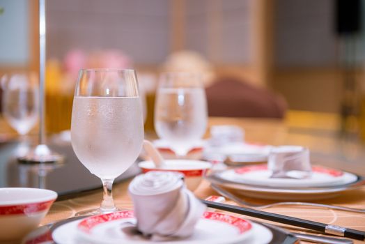 cool water glass on dining table in chinese restaurant