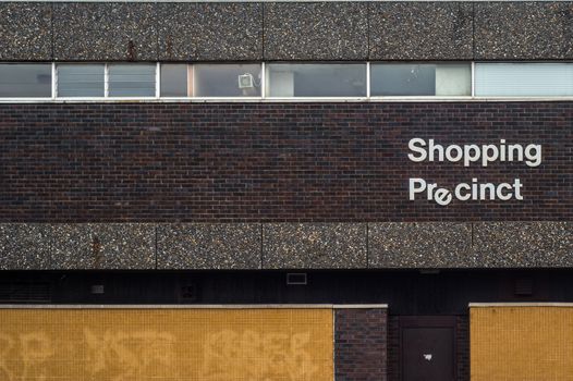 Recession Image Of A 1970s Style Grim Urban Rundown British Shopping Precinct Sign