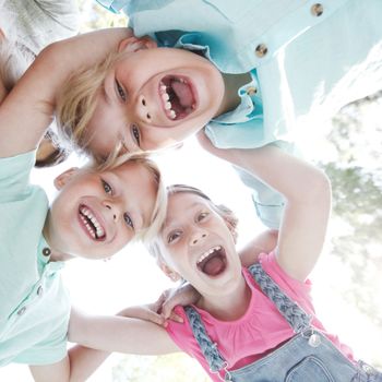 Group of smiling children looking down into camera