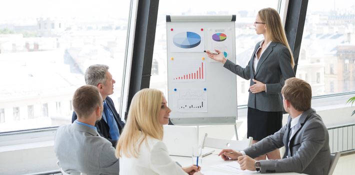 Business woman showing diagram during the presentation at business meeting in office