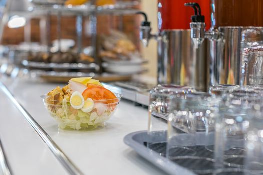 Bowl of Caesar salad on restaurant table closeup 