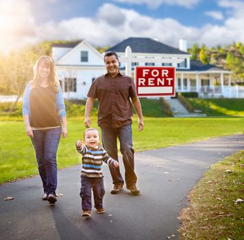 Happy Mixed Race Family Walking in Front of Home and For Rent Real Estate Sign.