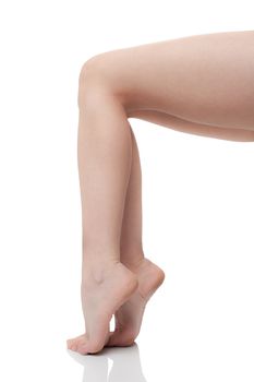 Naked female legs, profile view, on white background