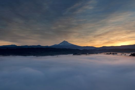 Rolling fog low clouds over Sandy River Valley and Mount Hood during sunrise